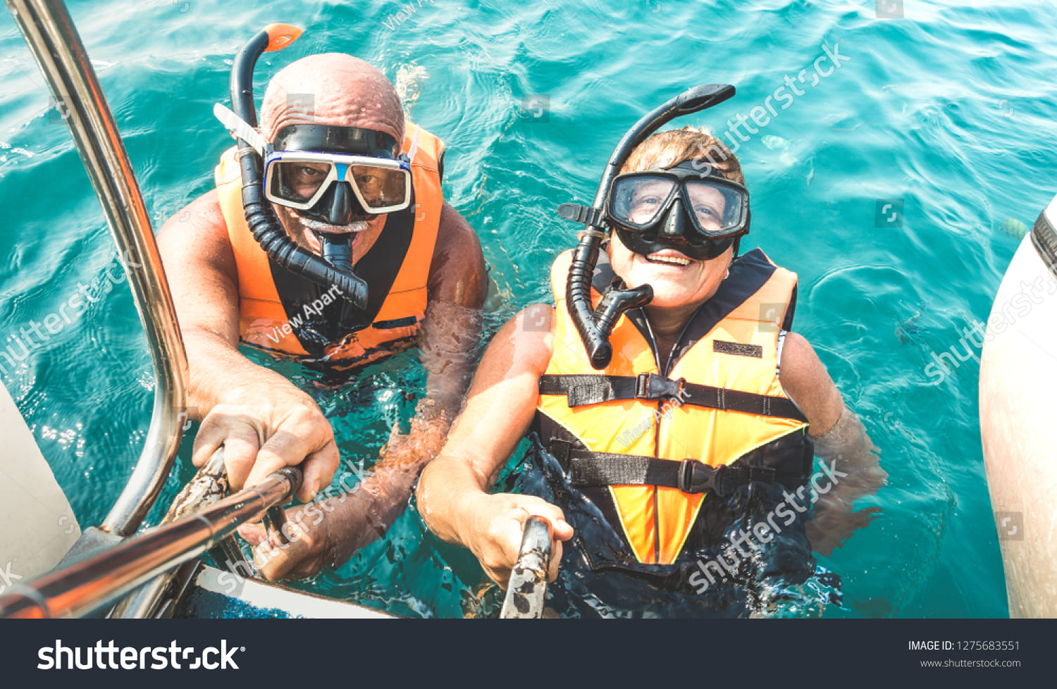 stock photo retired couple taking happy selfie in tropical sea excursion with life vests and snorkel masks 1275683551